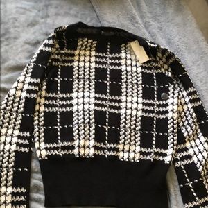 Black and white NY&C sweater with bell sleeves.